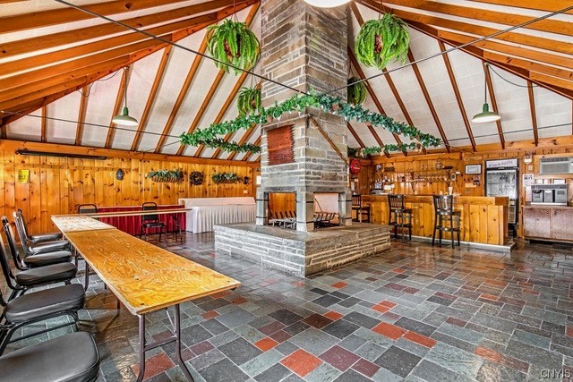 The stone fireplace and bar inside The Tepee