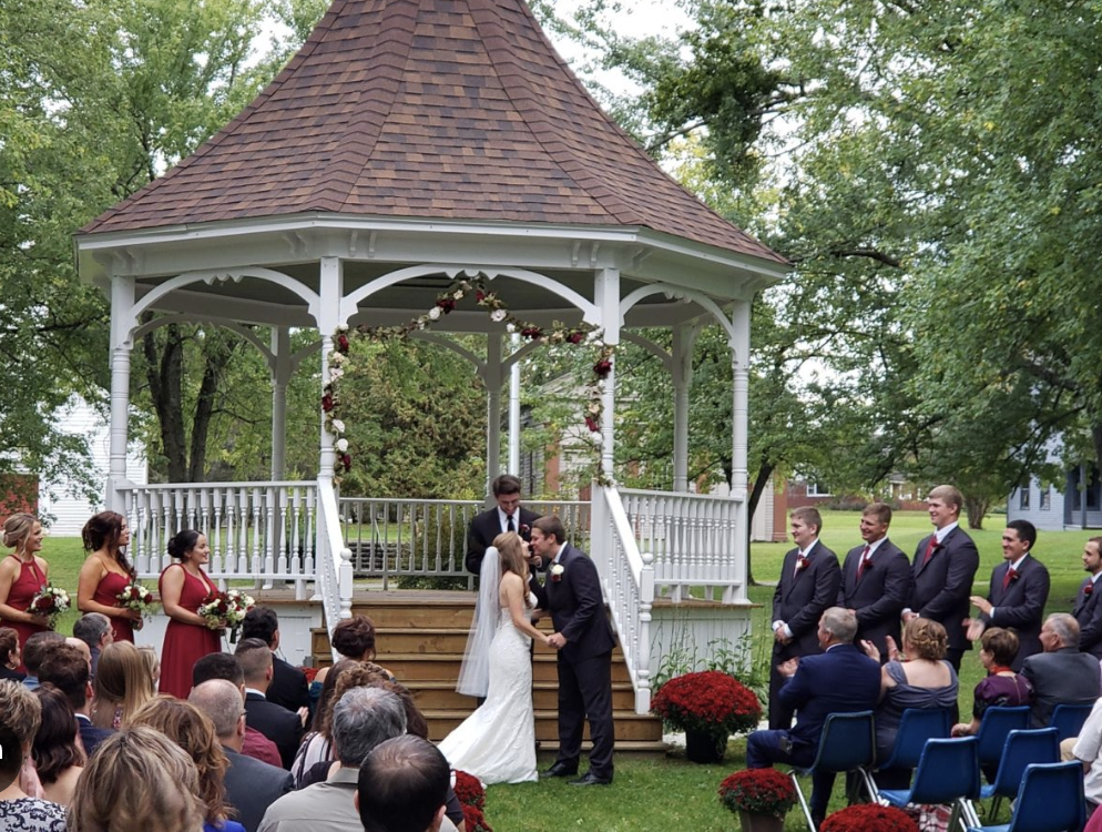 Gazebo ceremony surrounded by seated guests