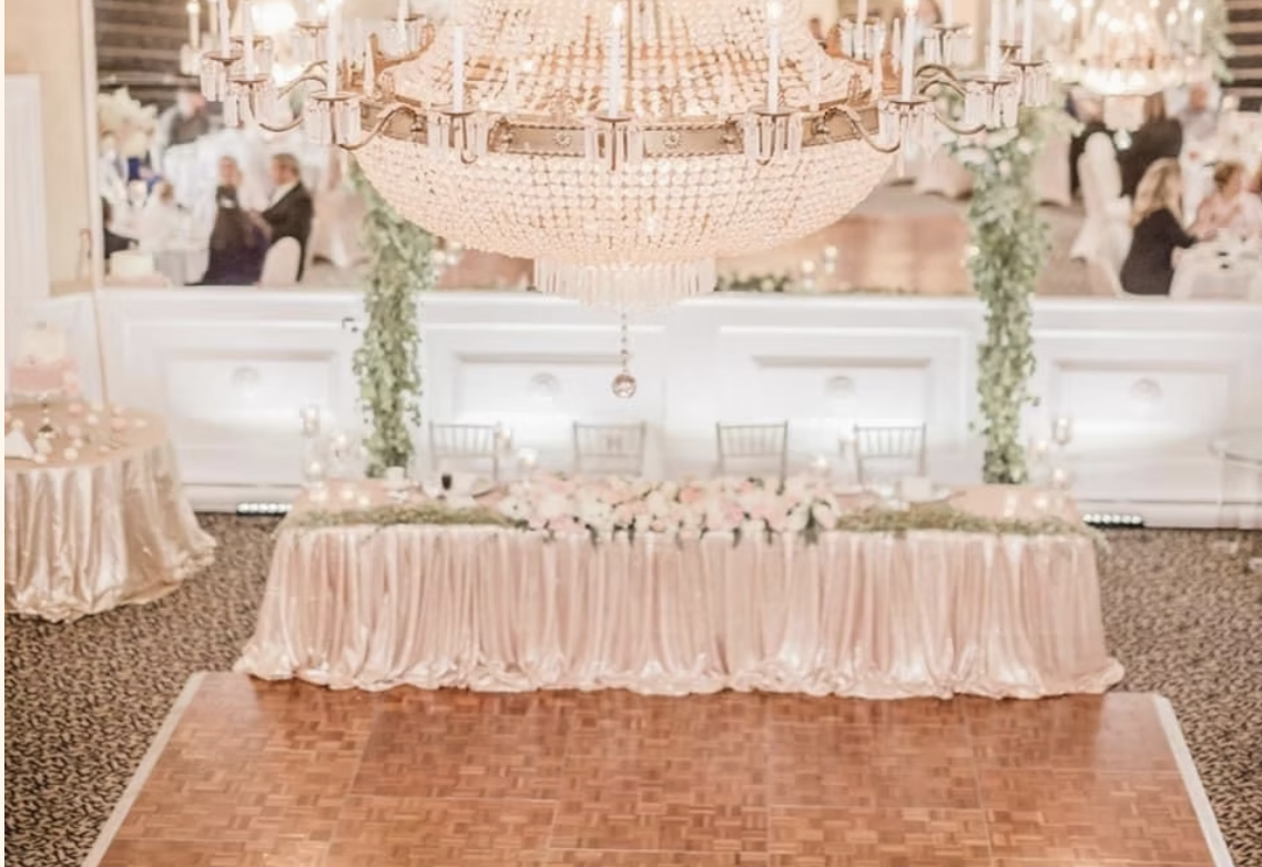 Sweetheart table beneath the crystal chandelier in The Appley