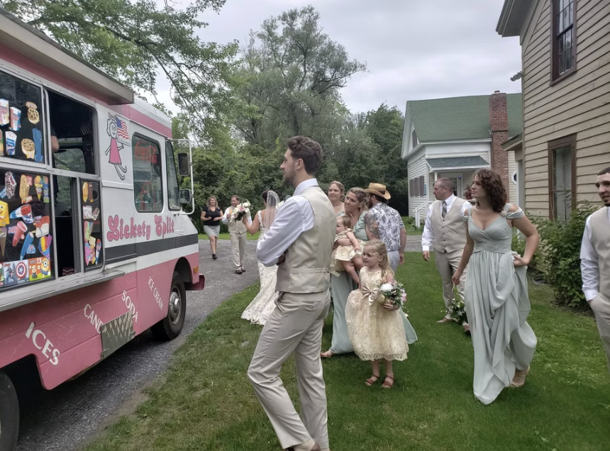 Wedding party gathered around a vintage ice cream truck at the reception
