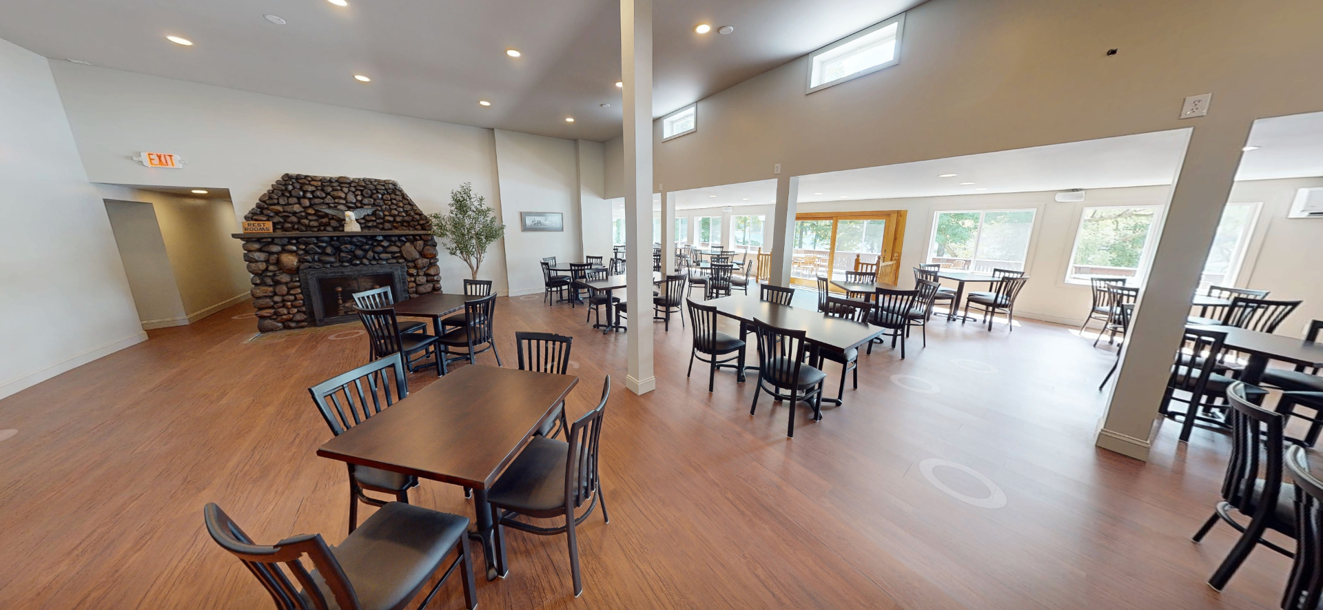 Stone fireplace and dining room at Luna on the Lake